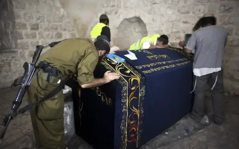 An Israeli soldier prays together with other worshippers inside Joseph's Tomb in the West Bank (photo credit: NIR ELIAS / REUTERS)