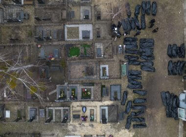 Policemen work to identify civilians who were killed during the Russian occupation in Bucha, Ukraine, on the outskirts of Kyiv, before sending the bodies to the morgue, Wednesday, April 6, 2022. (AP Photo/Rodrigo Abd)