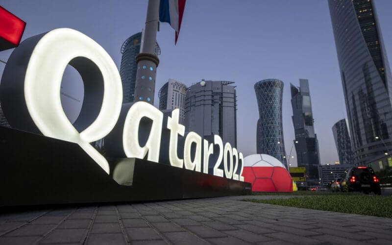Branding is displayed near the Doha Exhibition and Convention Center where soccer World Cup draw will be held, in Doha, Qatar, Thursday, March 31, 2022. The final draw will be held on April 1. (AP Photo/Darko Bandic)
