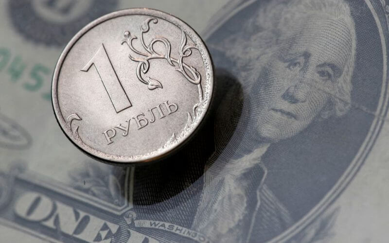 A view shows a Russian rouble coin and a U.S. dollar banknote in this picture illustration taken October 26, 2018. REUTERS/Maxim Shemetov/File Photo