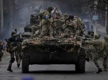 Ukrainian servicemen climb onto a fighting vehicle outside Kyiv, Ukraine, on April 2, 2022. (AP)