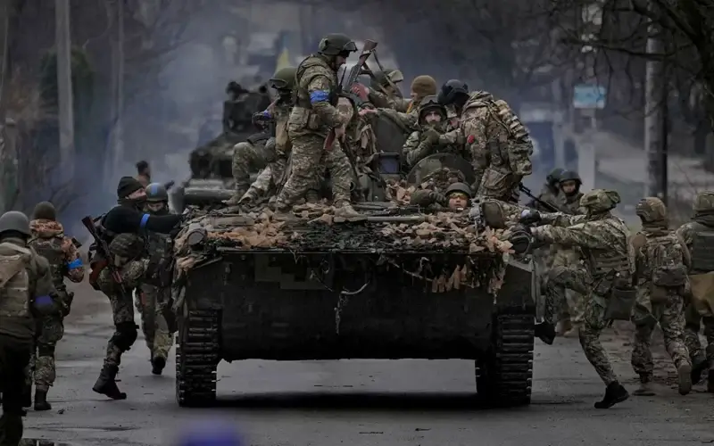Ukrainian servicemen climb onto a fighting vehicle outside Kyiv, Ukraine, on April 2, 2022. (AP)