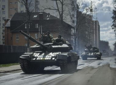 Ukrainian tanks move in a street in Irpin, in the outskirts of Kyiv, Ukraine, Monday, April 11, 2022. (AP Photo/Evgeniy Maloletka)