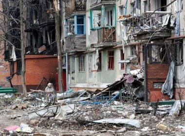 A local resident sits on a bench in a courtyard damaged during Ukraine-Russia conflict in the southern port city of Mariupol, Ukraine April 18, 2022. REUTERS/Alexander Ermochenko