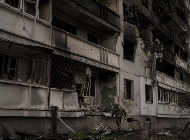 A Ukrainian serviceman inspects a heavily damaged apartment building after Russian bombardment in Kharkiv, Ukraine, Sunday, April 24, 2022. (AP Photo/Felipe Dana)