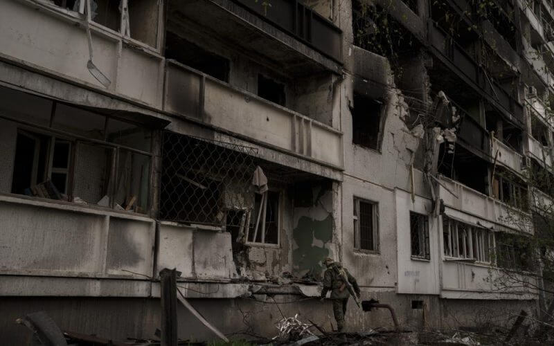 A Ukrainian serviceman inspects a heavily damaged apartment building after Russian bombardment in Kharkiv, Ukraine, Sunday, April 24, 2022. (AP Photo/Felipe Dana)