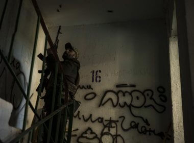 A Ukrainian serviceman walks in a building near a frontline position in Kharkiv, Ukraine, Monday, April 25, 2022. (AP Photo/Felipe Dana)