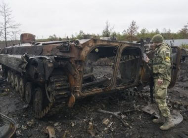 Ukrainian soldiers inspect a destroyed Russian tank in Bucha, Ukraine, on Sunday. Photo by Vladyslav Musienko/UPI