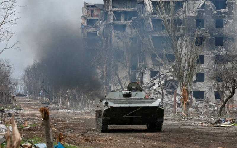 Service members of pro-Russian troops ride an armoured vehicle during fighting in Ukraine-Russia conflict near a plant of Azovstal Iron and Steel Works company in the southern port city of Mariupol, Ukraine April 12, 2022. REUTERS/Alexander Ermochenko