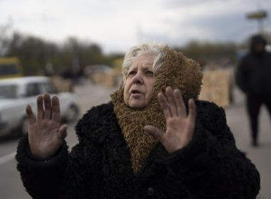 Valentina Greenchuck, 73, gestures after arriving from Mariupol at a refugee center in Zaporizhzhia, Ukraine, Thursday, April 21, 2022, after fleeing from the Russian attacks. Mariupol, which is part of the industrial region in eastern Ukraine known as the Donbas, has been a key Russian objective since the Feb. 24 invasion began. (AP Photo/Leo Correa)