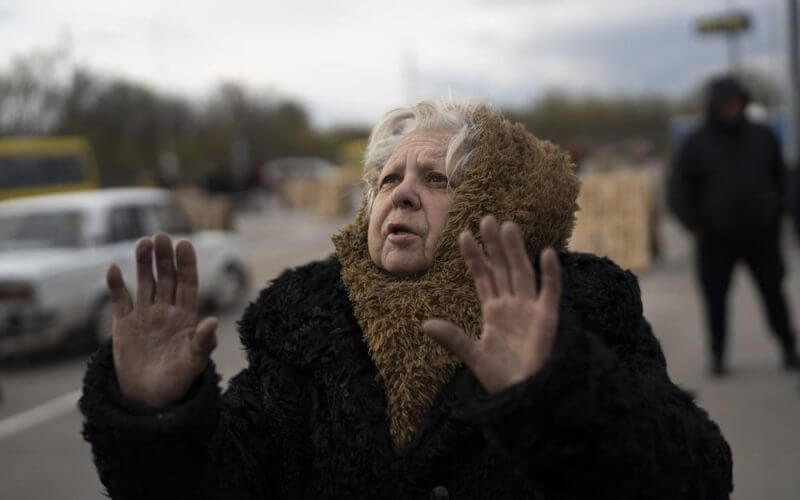 Valentina Greenchuck, 73, gestures after arriving from Mariupol at a refugee center in Zaporizhzhia, Ukraine, Thursday, April 21, 2022, after fleeing from the Russian attacks. Mariupol, which is part of the industrial region in eastern Ukraine known as the Donbas, has been a key Russian objective since the Feb. 24 invasion began. (AP Photo/Leo Correa)