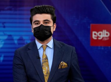 TV anchor Nesar Nabil wears a face mask to protest the Taliban's new order that female presenters cover their faces, as he reads the news on TOLOnews, in Kabul, Afghanistan, Sunday, May 22, 2022. (AP Photo/Ebrahim Noroozi)