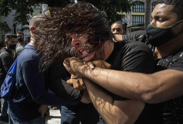In this July 11, 2021 file photo, plainclothes police detain an anti-government protester during a demonstration over high prices, food shortages and power outages, while some also called for a change in the government, in Havana, Cuba. (AP Photo/Ramon Espinosa, File)