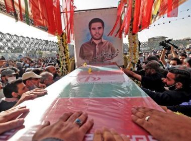 Mourners gather around the coffin of Iran's Revolutionary Guards colonel Sayyad Khodai during a funeral procession at Imam Hussein square in the capital Tehran, on May 24, 2022. AFP
