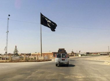 A motorist passes by a flag of the Islamic State group in central Rawah, 175 miles (281 kilometers) northwest of Baghdad, Iraq, July 22, 2014. Members of the global coalition fighting the Islamic State group are meeting in Morocco on Wednesday May 11, 20222 to discuss ongoing efforts in the campaign. The meeting is a reminder of the persistent threat from the extremist group despite the overwhelming preoccupation with Russia’s war on Ukraine. (AP Photo, File)