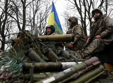 Ukrainian soldiers stand on their armored personnel carrier (APC), not far from the front-line with Russian troops, in Izyum district, Kharkiv region on April 18, 2022, during the Russian invasion of Ukraine. (Anatolii Stepanov / AFP)