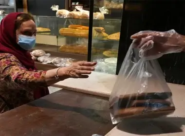 A customer buys bread in a bakery in Tehran, Iran, Wednesday, May 11, 2022. (AP Photo/Vahid Salemi)