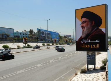 Vehicles drive past billboards depicting Lebanon's Hezbollah leader Sayyed Hassan Nasrallah, ahead of parliamentary election, in Beirut, Lebanon May 13, 2022. REUTERS/Aziz Taher
