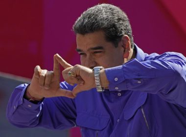 Venezuela's President Nicolas Maduro gestures on stage during a May Day rally in Caracas, Venezuela, Sunday, May 1, 2022. (AP Photo/Ariana Cubillos)