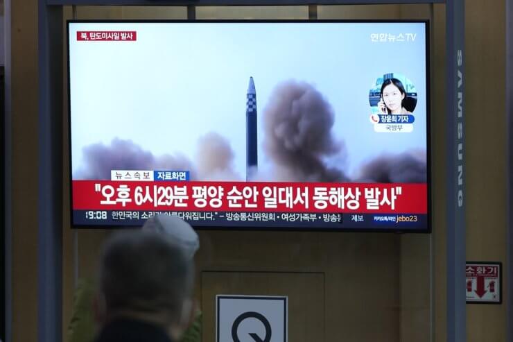 People watch a TV screen showing a news program reporting about North Korea's missile launch with file footage at Seoul Station, Thursday. AP-Yonhap