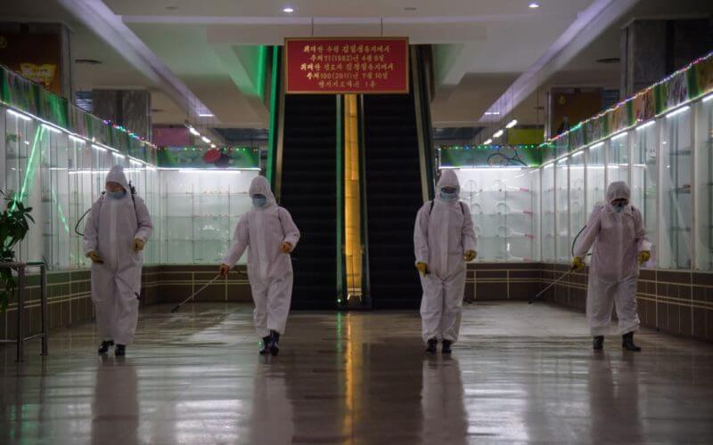In this file photo taken on December 28, 2020 health workers spray disinfectant inside the Pyongyang Department Store No. 1 prior to opening for business, in Pyongyang. Photo: AFP