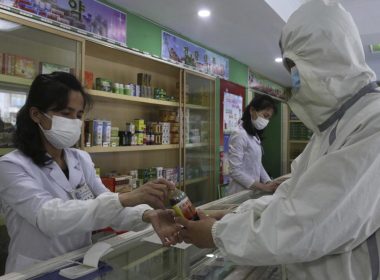 An employees of the Medicament Management Office of the Daesong District in Pyongyang provides medicine to a resident as the state increases measures to stop the spread of illness in Pyongyang, North Korea, Monday, May 16, 2022. (AP Photo/Jon Chol Jin)