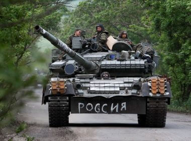 Service members of pro-Russian troops drive a tank during Ukraine-Russia conflict in the Donetsk Region, Ukraine May 22, 2022. The writing on the tank reads: "Russia". REUTERS/Alexander Ermochenko