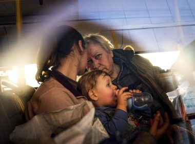 People with children wait after arriving from the Ukrainian city of Mariupol at a center for displaced people in Zaporizhzhia, Ukraine, Tuesday, May 3, 2022. (AP Photo/Evgeniy Maloletka)