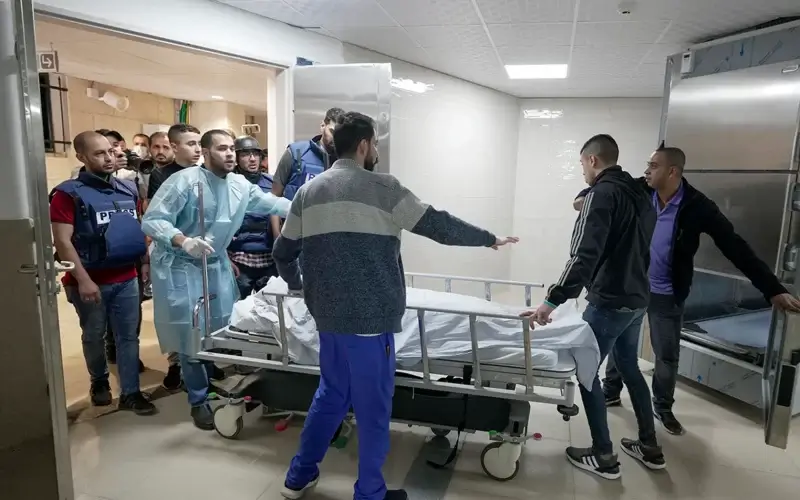 Journalists and medics wheel the body of Shireen Abu Akleh, a journalist for Al Jazeera network, into the morgue inside the Hospital in the West Bank town of Jenin, Wednesday, May 11, 2022. (AP Photo/Majdi Mohammed)
