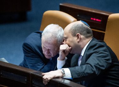 Prime Minister Naftali Bennett, right, with Minister of Defense Benny Gantz during a plenum session at the Knesset, on February 28, 2022. (Yonatan Sindel/Flash90)