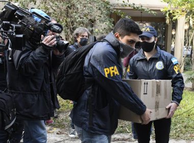 Police officers confiscate a box of documents during a judicial raid at the Plaza Central Hotel where the crew of a Venezuelan-owned Boeing 747 cargo plane are staying, in Buenos Aires, Argentina, Tuesday, June 14, 2022. (AP Photo/Gustavo Garello)