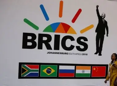 A delegate walks past a BRICS logo ahead of the 10th BRICS Summit, in Sandton, South Africa, July 24, 2018. REUTERS/Siphiwe Sibeko