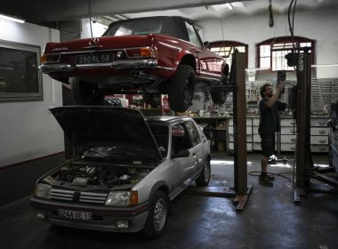Mechanic Frederic Mistre works on a combustion engine car at a garage in Marseille, southern France, Wednesday, June 8, 2022. (AP Photo/Daniel Cole)