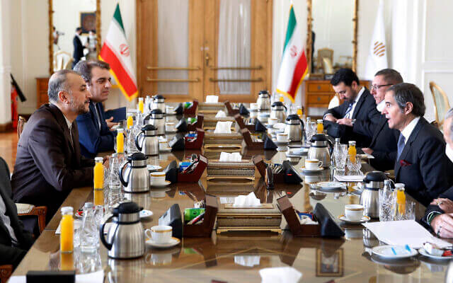 International Atomic Energy Organization Director-General Rafael Mariano Grossi, right, speaks with Iran’s Foreign Minister Hossein Amirabdollahian, left, during their meeting in Tehran, March 5, 2022. (AP Photo)