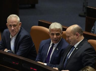 Israeli Defense Minister Benny Gantz, left, Foreign Minister Yair Lapid, center, and Prime Minister Naftali Bennett attend a preliminary vote on a bill to dissolve parliament, at the Knesset, Israel's parliament, in Jerusalem, Wednesday, June 22, 2022. (AP Photo/Maya Alleruzzo)