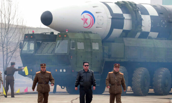 North Korean leader Kim Jong Un (C) walks around a Hwasong-17 intercontinental ballistic missile (ICBM) on the launcher at an undisclosed location in North Korea on March 24, 2022. (Korean Central News Agency/Korea News Service via AP)