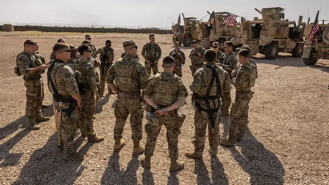 This file photo shows U.S. Army soldiers as they prepare to go out on patrol from a remote combat outpost on May 25, 2021, in northeastern Syria. (John Moore/Getty Images, File)