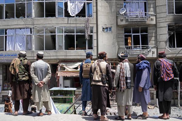 Taliban fighters gather at the site of an explosion in front of a Sikh temple in Kabul, Afghanistan, Saturday, June 18, 2022. (AP Photo/Ebrahim Noroozi)