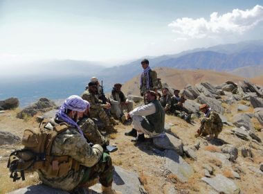 Afghan resistance movement and anti-Taliban uprising forces take a rest as they patrol on a hilltop in Panjshir province, Afghanistan, on Sept. 1, 2021. AHMAD SAHEL ARMAN/AFP VIA GETTY IMAGES