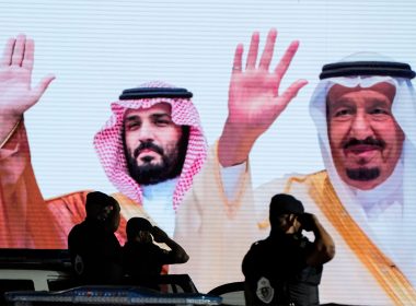 Saudi special forces troops salute in front of a screen displaying images Saudi King Salman, right, and Crown Prince Mohammed bin Salman after a military parade in preparation for the annual Hajj pilgrimage, in the Muslim holy city of Mecca, Saudi Arabia, July 3, 2022. (AP Photo/Amr Nabil, File)