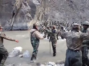 This video frame grab taken from footage recorded in mid-June 2020 and released by China Central Television (CCTV) on Feb. 20, 2021, shows Chinese (foreground) and Indian soldiers (R, background) during an incident where troops from both countries clashed in the Line of Actual Control (LAC) in the Galwan Valley.