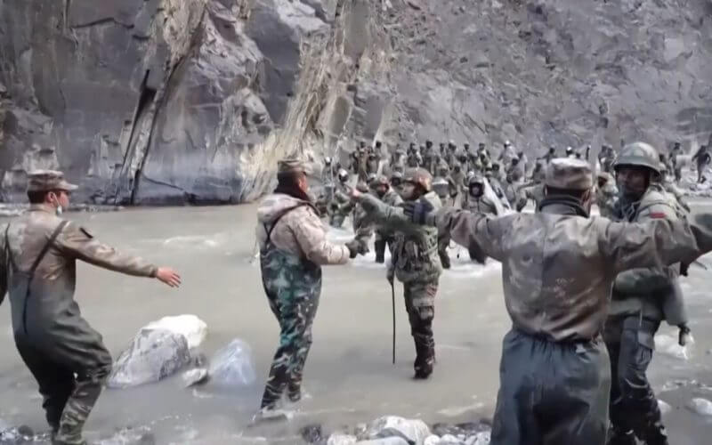 This video frame grab taken from footage recorded in mid-June 2020 and released by China Central Television (CCTV) on Feb. 20, 2021, shows Chinese (foreground) and Indian soldiers (R, background) during an incident where troops from both countries clashed in the Line of Actual Control (LAC) in the Galwan Valley.