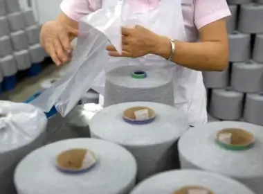 A worker packages spools of cotton yarn at a textile manufacturing plant, as seen during a government organized trip for foreign journalists last year, in Aksu in western China's Xinjiang Uyghur Autonomous Region. (Mark Schiefelbein/AP File)