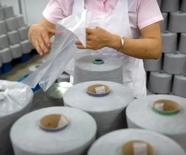 A worker packages spools of cotton yarn at a textile manufacturing plant, as seen during a government organized trip for foreign journalists last year, in Aksu in western China's Xinjiang Uyghur Autonomous Region. (Mark Schiefelbein/AP File)
