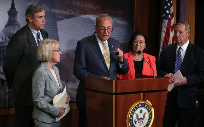 Senate Majority Leader Chuck Schumer (D., N.Y.) with members of his caucus / Getty Images