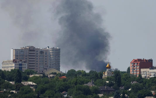 Smoke rises after shelling during Ukraine-Russia conflict in Donetsk. Reuters/ALEXANDER ERMOCHENKO