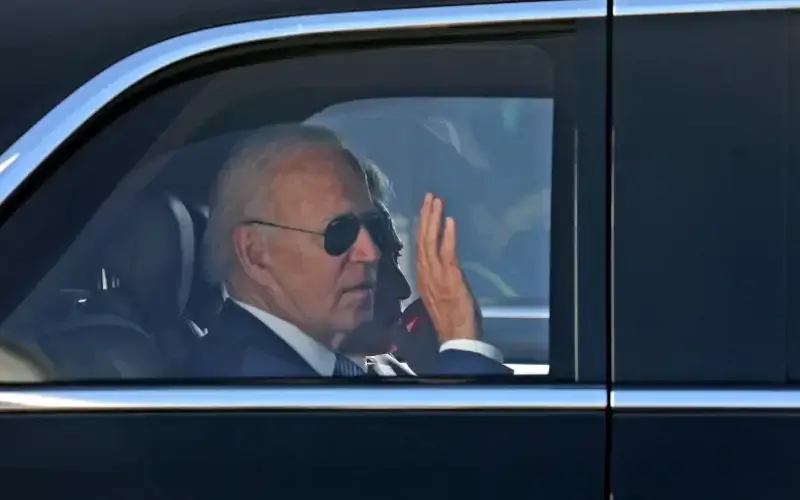 US President Joe Biden waves as he leaves Israel's Ben Gurion Airport, on his way to Jersualem, near Tel Aviv, Israel, July 13, 2022 (photo credit: GIL COHEN-MAGEN/POOL VIA REUTERS)