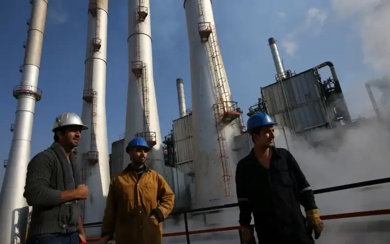Iranian oil workers gather at an oil refinery south of Tehran. Vahid Salem/AP Photo