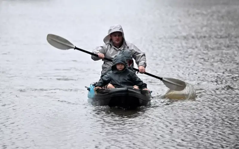 People kayak along a flooded street in the Windsor suburb of Sydney. Photo: Saeed Khan/AFP via Getty Images