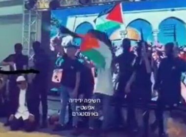 Screenshot from a video uploaded to social media showing students at the Anata High School for boys in East Jerusalem in a play that includes students dressed up as gunmen "shooting" students dressed up as religious Jews, July 20, 2022. (Twitter)